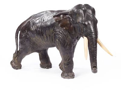 Seiya Genryusai : A massive Japanese bronze model of an Indian bull elephant with ivory tusks